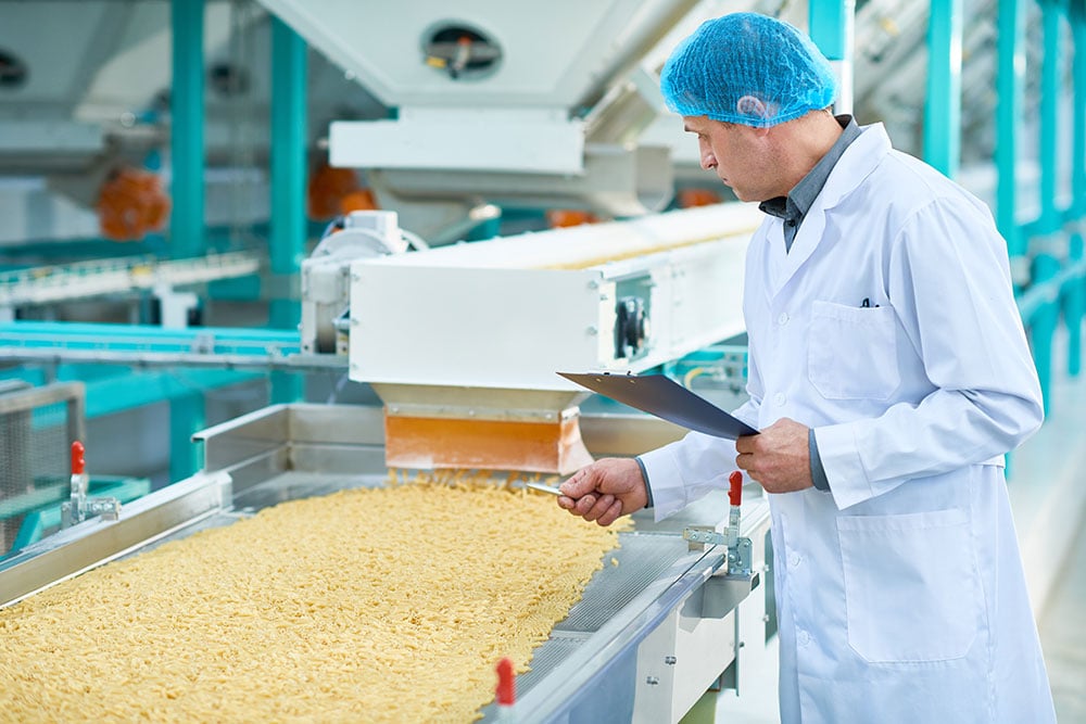 factory worker doing production quality inspection in food industry