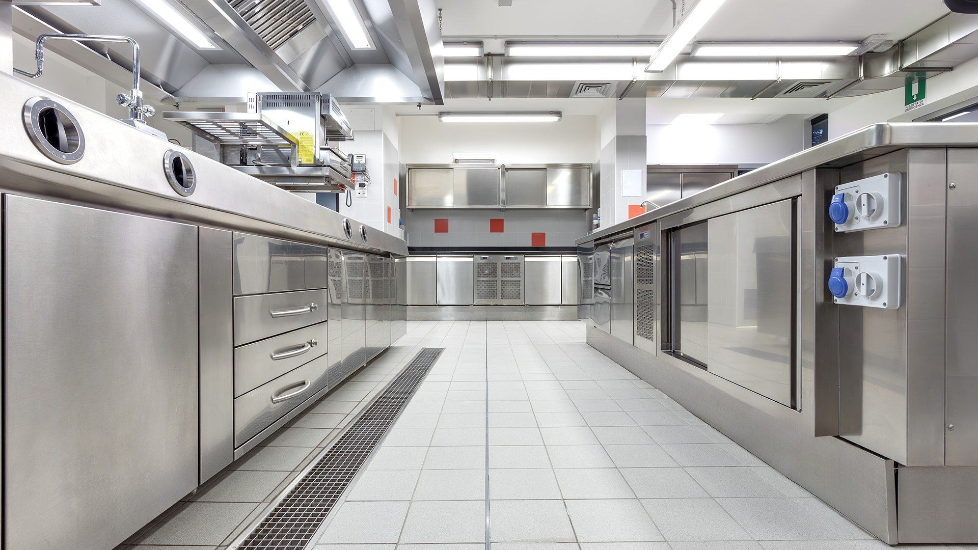 Drain in a clean commercial kitchen or food processing area.